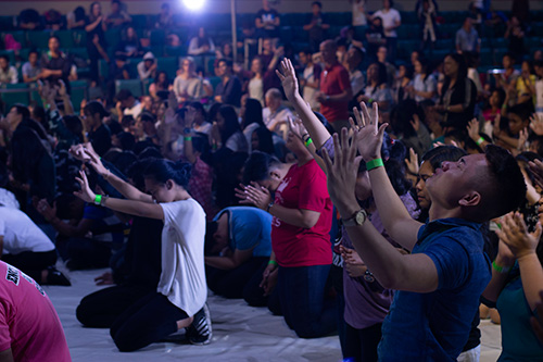 Manila_GYO_worship_application_on_knees_hands_raised_resized.jpg